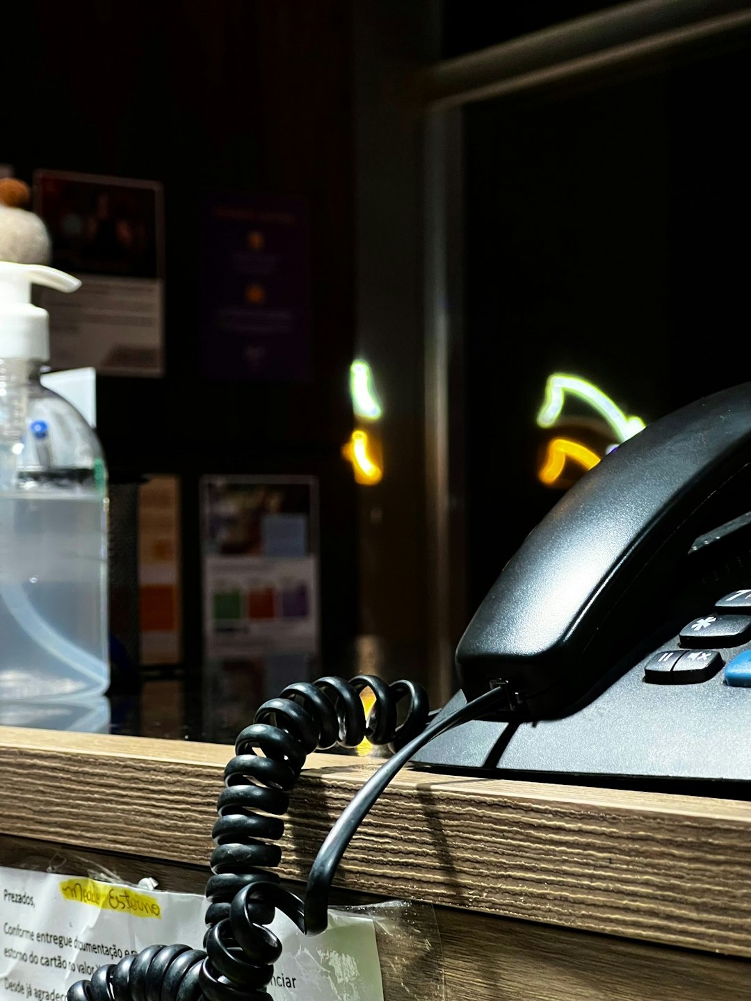 A phone is plugged into a cord on a desk